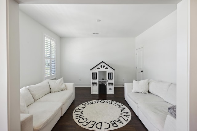 living room with baseboards and dark wood-style flooring