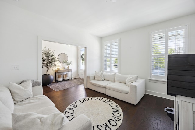 living area with dark wood finished floors and baseboards