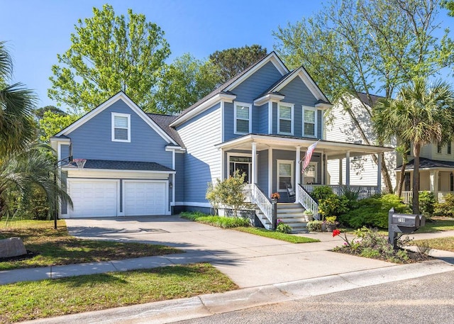 traditional-style house featuring a porch, an attached garage, and driveway