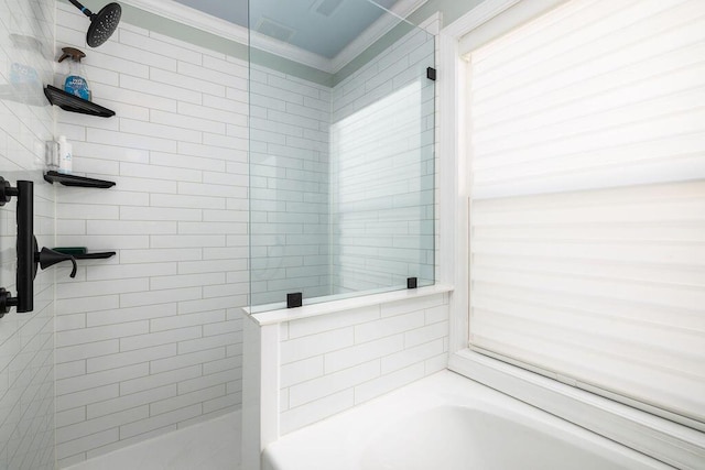 full bath featuring crown molding, a bath, and a tile shower