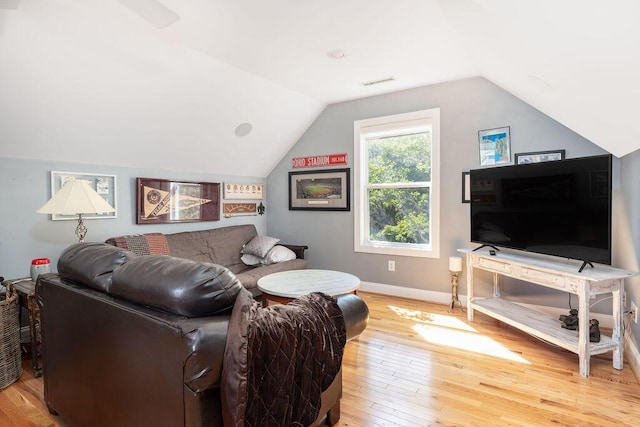living area with vaulted ceiling, baseboards, light wood-type flooring, and visible vents