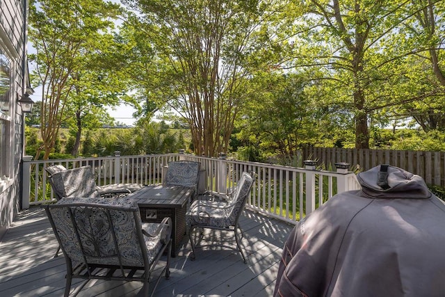 wooden deck featuring fence and outdoor dining space