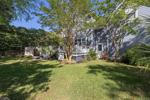 view of yard featuring a wooden deck and fence