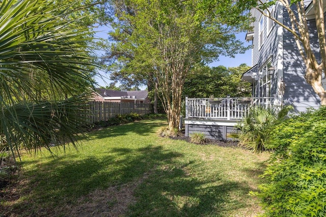 view of yard featuring a wooden deck and fence