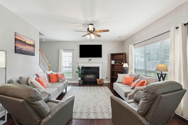 living room with dark hardwood / wood-style floors and ceiling fan