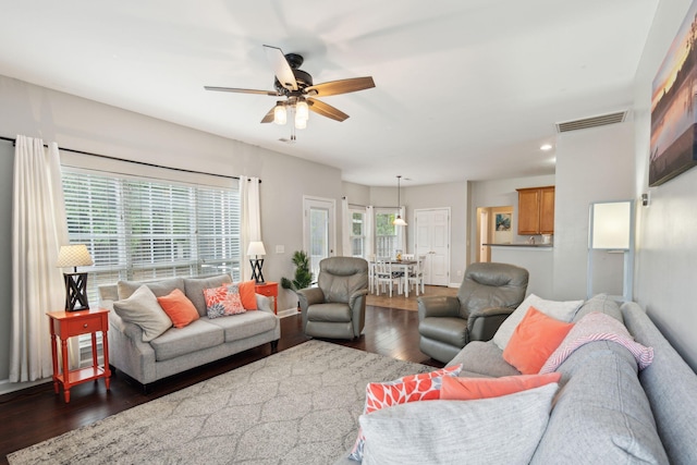 living room with ceiling fan, dark hardwood / wood-style floors, and a wealth of natural light