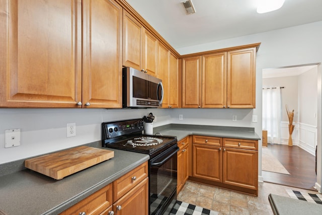 kitchen with light wood-type flooring and black electric range