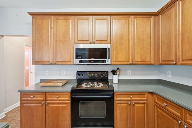 kitchen with black range with electric stovetop and light tile patterned floors