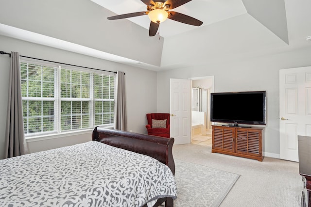 bedroom featuring a raised ceiling, ensuite bath, ceiling fan, and light colored carpet