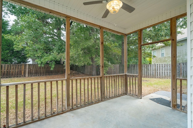 sunroom with ceiling fan, wooden ceiling, and a healthy amount of sunlight