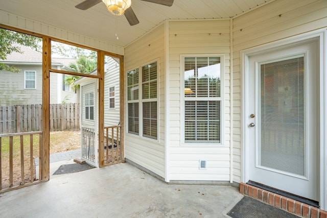 unfurnished sunroom with lofted ceiling and ceiling fan