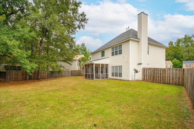 exterior space featuring a yard and a sunroom