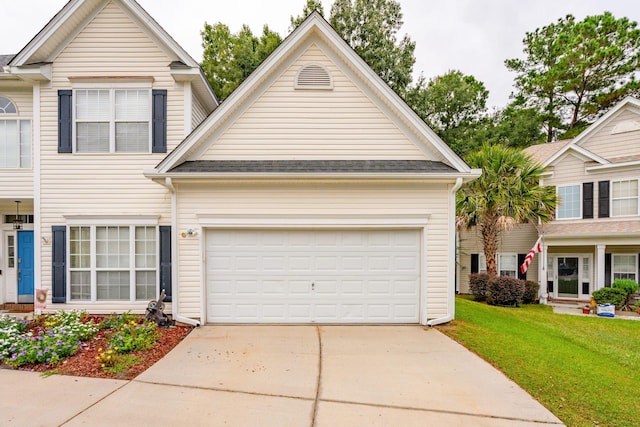 view of front facade featuring a front lawn and a garage