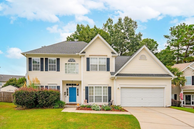 view of front of home featuring a garage and a front lawn