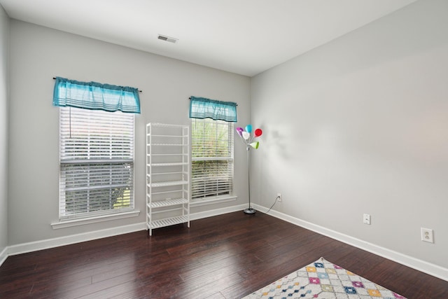 empty room with dark hardwood / wood-style floors