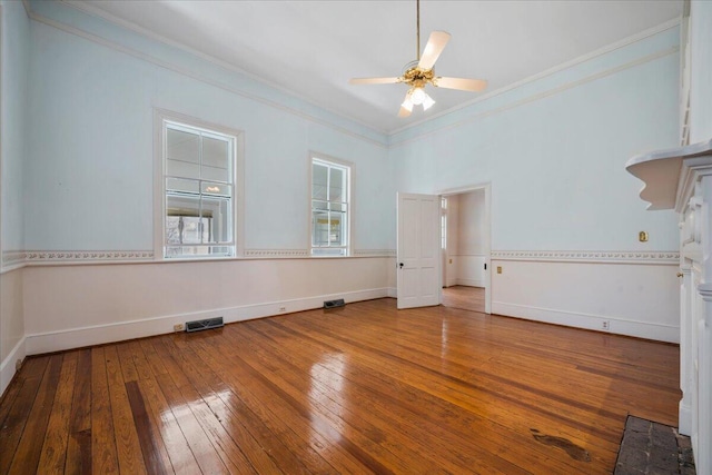 spare room with hardwood / wood-style floors, ornamental molding, and ceiling fan