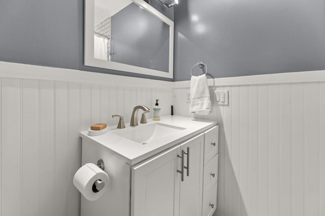 bathroom with a wainscoted wall and vanity