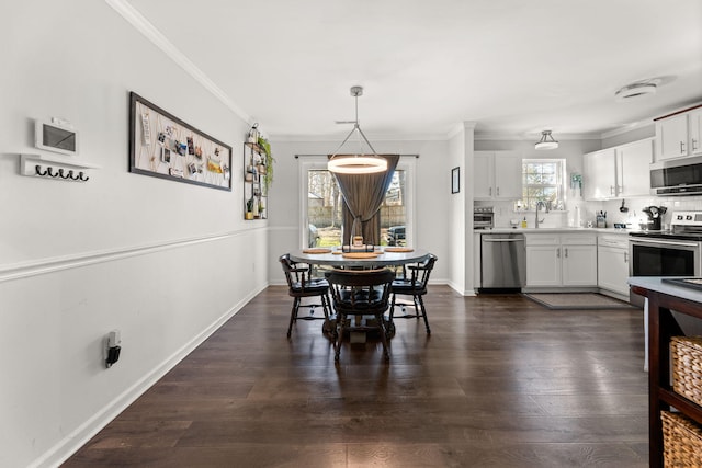 dining area with dark wood-style floors, baseboards, and ornamental molding