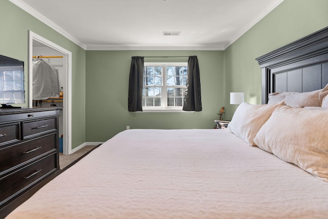 bedroom featuring visible vents, carpet floors, baseboards, and ornamental molding