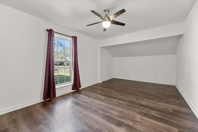 additional living space featuring baseboards, lofted ceiling, a ceiling fan, and wood finished floors