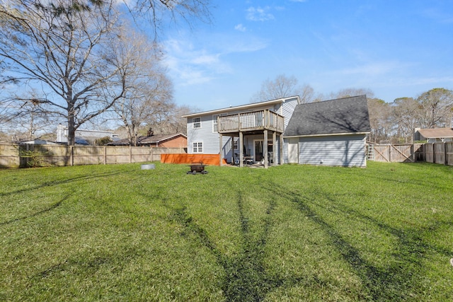 rear view of house featuring a lawn, a fenced backyard, and a wooden deck