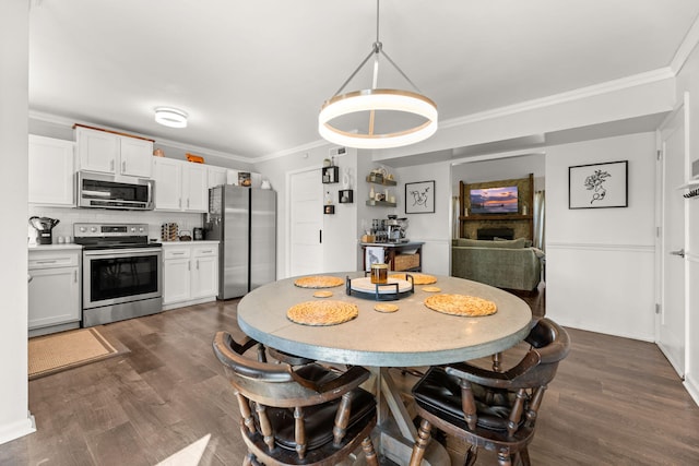 dining room with dark wood-style floors and crown molding