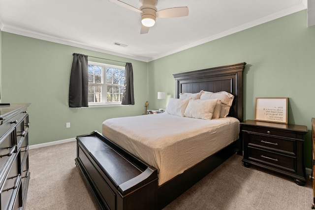 carpeted bedroom featuring ceiling fan, visible vents, baseboards, and ornamental molding