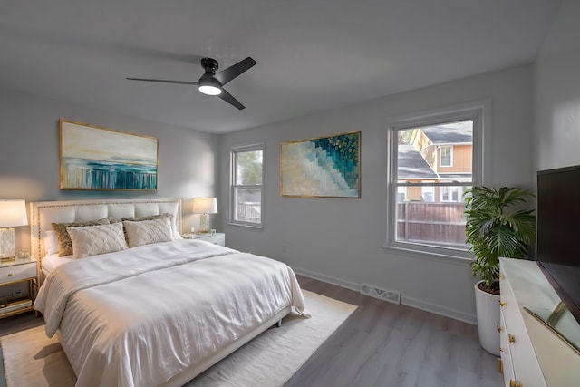 bedroom with ceiling fan and light hardwood / wood-style floors