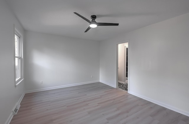 spare room featuring ceiling fan and light hardwood / wood-style flooring