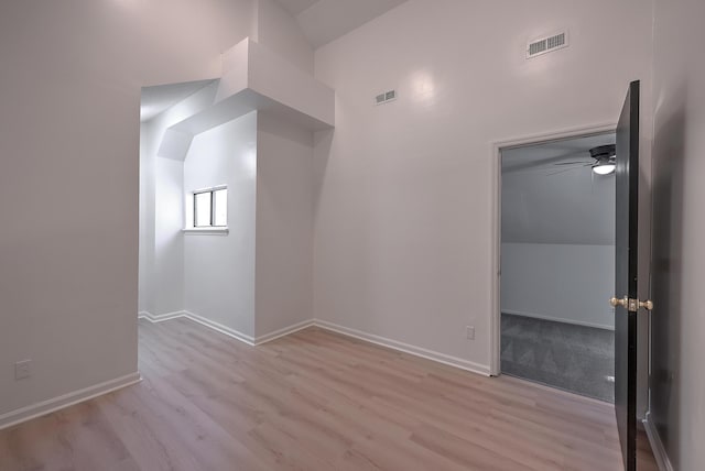 interior space with vaulted ceiling, light hardwood / wood-style flooring, and ceiling fan