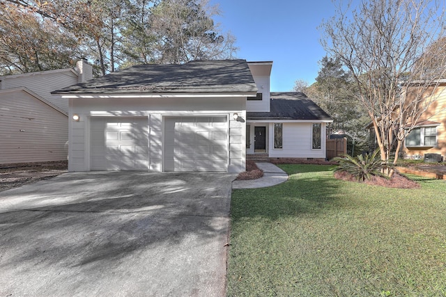 view of front of property featuring a garage and a front yard