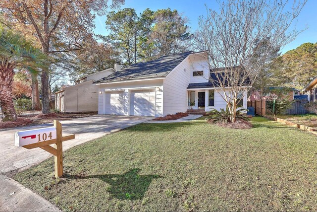 view of front of house with a garage and a front lawn