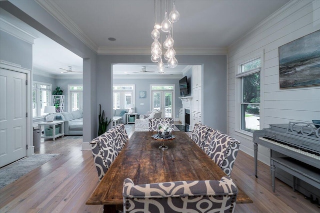 764 Post Oak Dr, Mount Pleasant, SC 29464 - dining space with a ceiling fan, wood finished floors, a fireplace, plenty of natural light, and crown molding