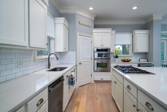 764 Post Oak Dr, Mount Pleasant, SC 29464 - kitchen with a sink, appliances with stainless steel finishes, plenty of natural light, white cabinetry, and ornamental molding