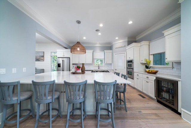 764 Post Oak Dr, Mount Pleasant, SC 29464 - kitchen with wine cooler, stainless steel appliances, a kitchen bar, decorative backsplash, and a peninsula