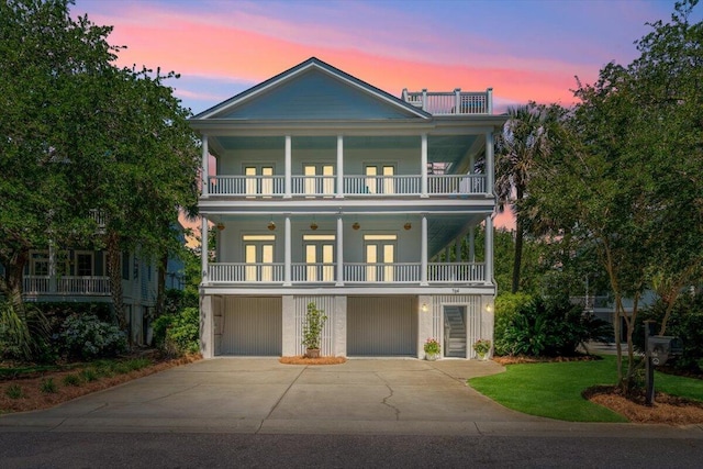 764 Post Oak Dr, Mount Pleasant, SC 29464 - view of front facade with a balcony, french doors, driveway, and an attached garage