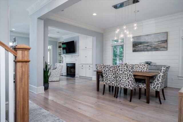 764 Post Oak Dr, Mount Pleasant, SC 29464 - dining space featuring light wood-style flooring, a fireplace, recessed lighting, ornamental molding, and baseboards