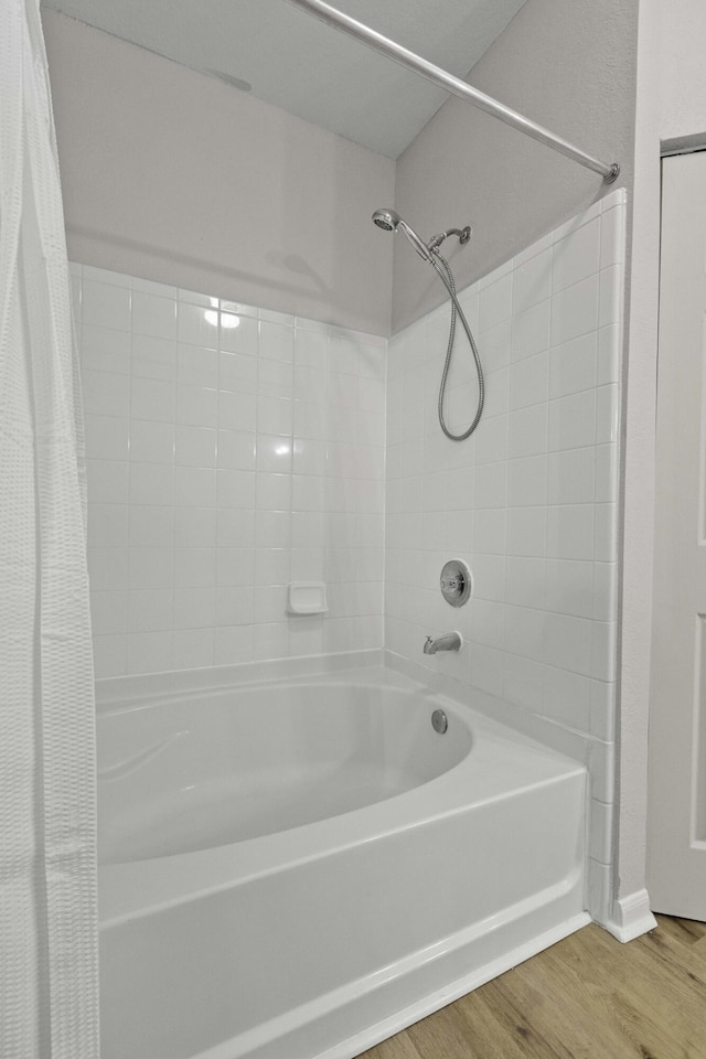 bathroom featuring shower / bath combination with curtain and wood finished floors