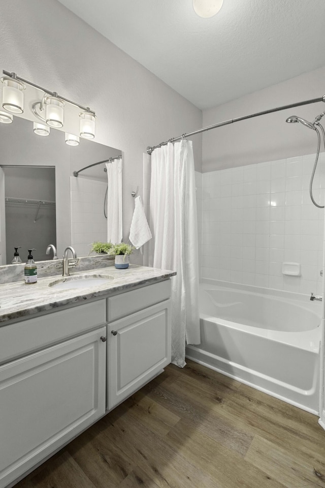 full bathroom featuring shower / bath combo with shower curtain, vanity, and wood finished floors