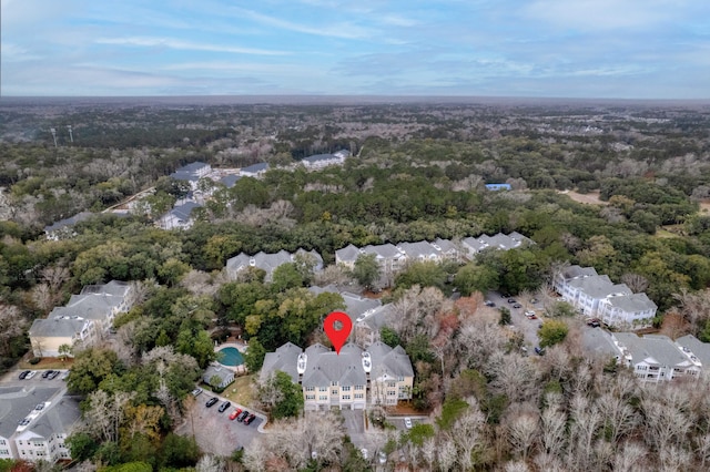 birds eye view of property with a view of trees