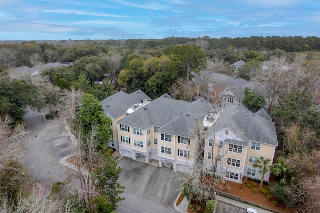 drone / aerial view featuring a wooded view