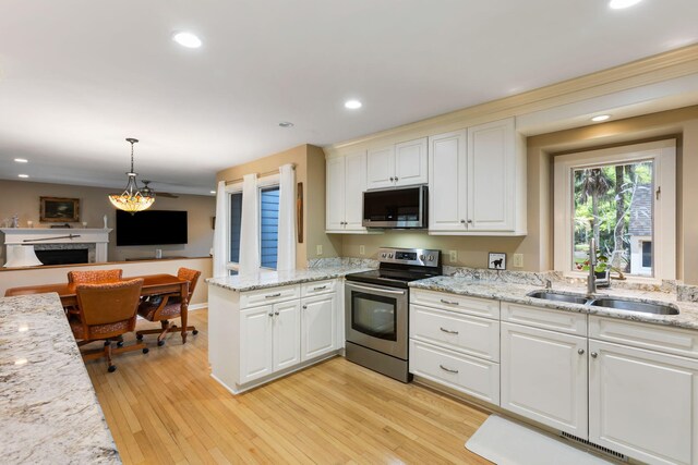 2653 Seabrook Island Rd, Seabrook Island, SC 29455 - kitchen featuring stainless steel appliances, a peninsula, a sink, white cabinetry, and recessed lighting