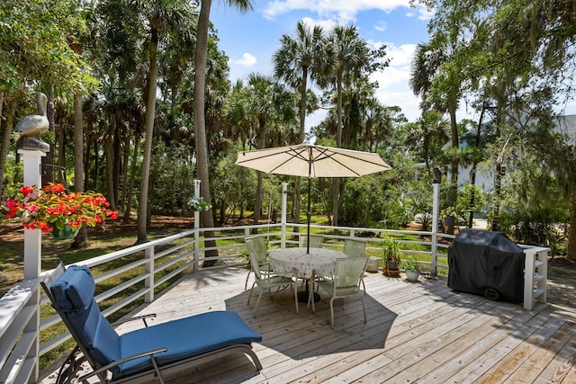 2653 Seabrook Island Rd, Seabrook Island, SC 29455 - wooden deck featuring outdoor dining area and view of scattered trees