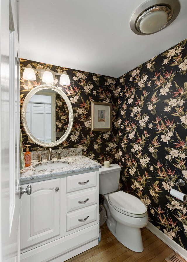 2653 Seabrook Island Rd, Seabrook Island, SC 29455 - half bath featuring wood finished floors, wallpapered walls, vanity, toilet, and baseboards