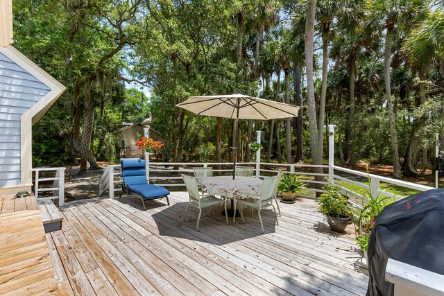2653 Seabrook Island Rd, Seabrook Island, SC 29455 - wooden terrace featuring outdoor dining area, area for grilling, and view of scattered trees