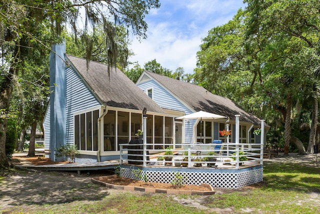 2653 Seabrook Island Rd, Seabrook Island, SC 29455 - back of property featuring a sunroom, a shingled roof, and a wooden deck