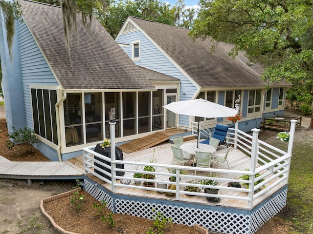 2653 Seabrook Island Rd, Seabrook Island, SC 29455 - rear view of house featuring a sunroom, a shingled roof, a deck, and outdoor dining space