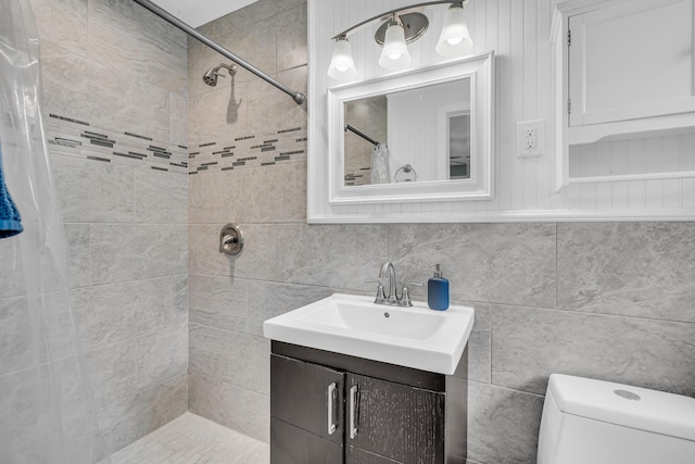 bathroom with vanity, toilet, curtained shower, and tile walls