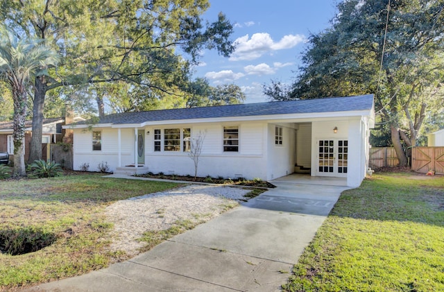 ranch-style home with a front lawn and a carport