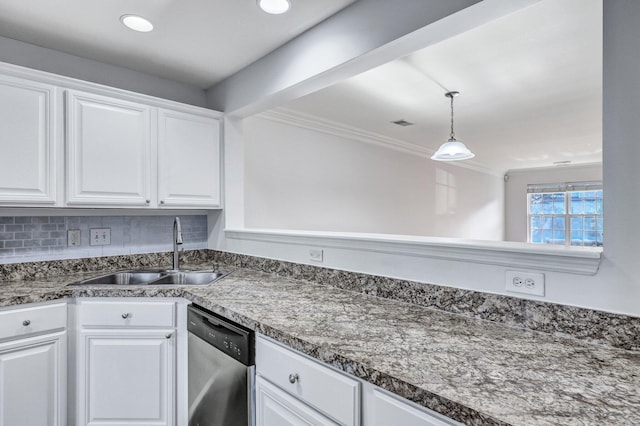 kitchen featuring dishwasher, dark countertops, a sink, and white cabinetry